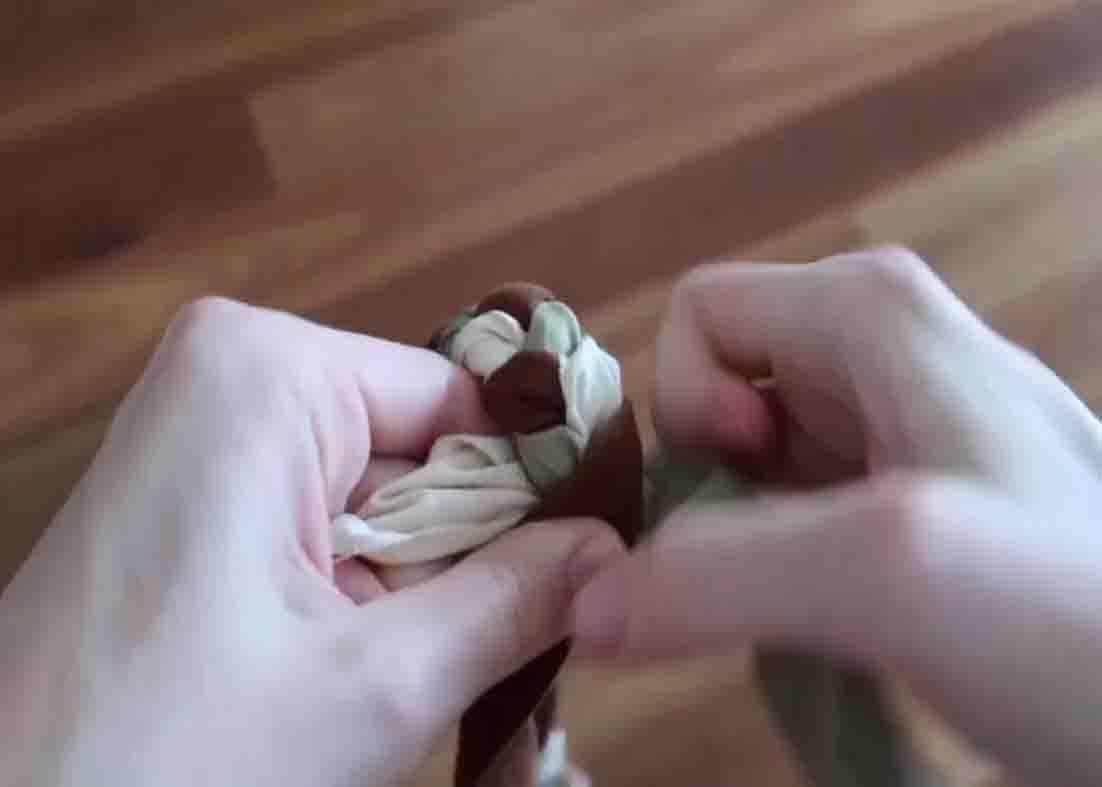 Plaiting the fabric scraps to make the fabric basket