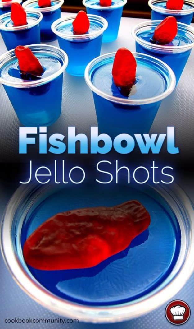 Fishbowl jello shots in clear cups, bright blue set jello with gummy fish suspended in the middle of each