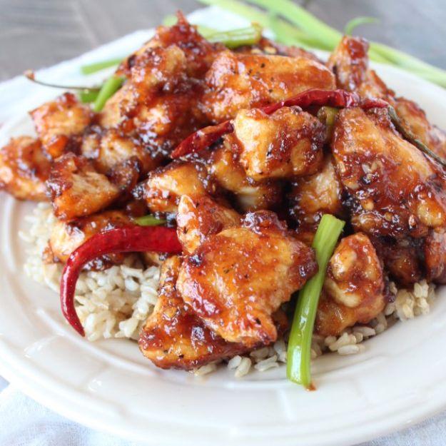 Gluten free General Tso chicken glazed in dark sauce with whole dried red chilies and scallions over brown rice