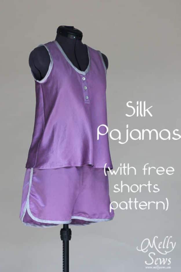 Purple silk pajama set with a sleeveless button top and matching shorts, displayed on a black dress form