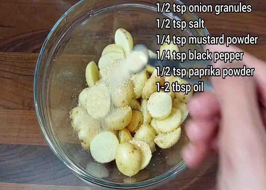 Seasoning the baby potatoes with herbs and spices
