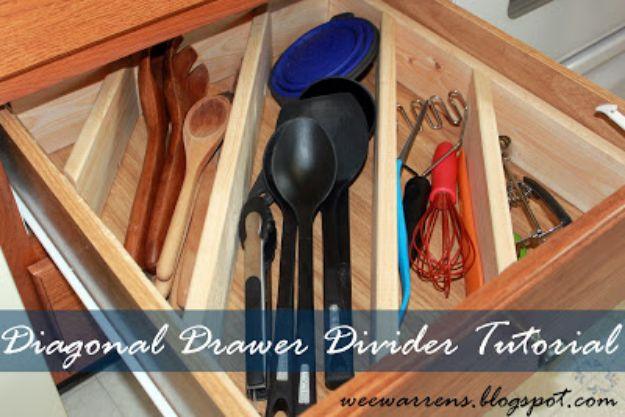 Kitchen drawer fitted with a wooden diagonal divider holding spoons, spatulas, a whisk and tongs in angled slots