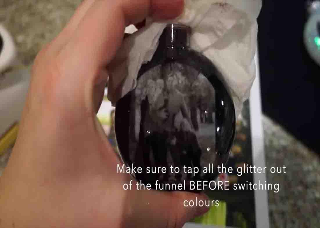 Filling the Christmas photo ornament with glitter
