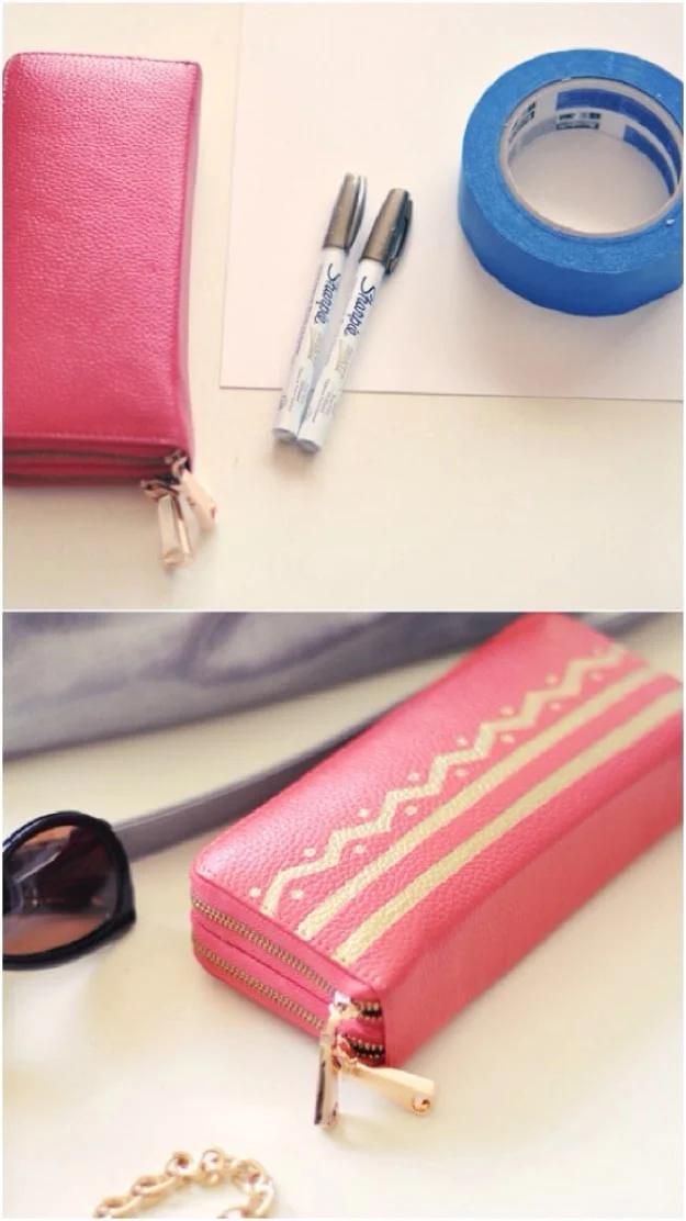 Sharpie chevron wallet, a coral pink leather zip wallet painted with gold chevron stripes beside two paint pens