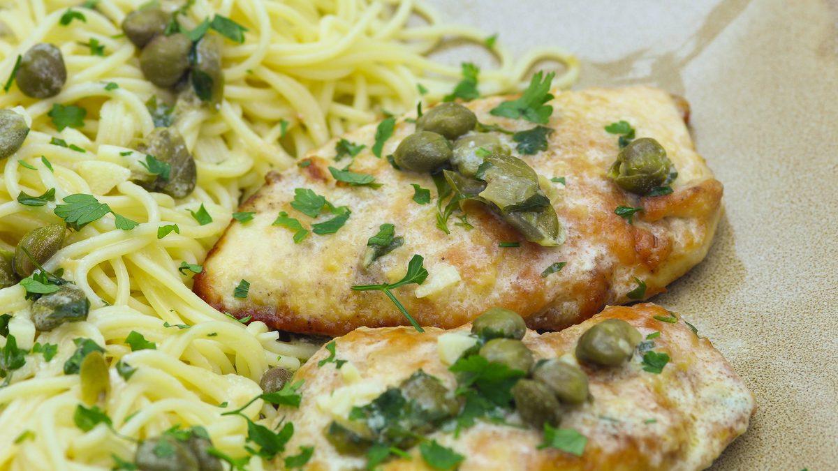 Easy chicken piccata, golden chicken cutlets in lemon caper sauce over angel hair pasta with fresh parsley