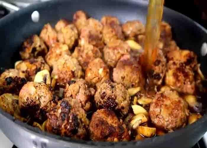 Smothering the meatballs with salisbury steak sauce