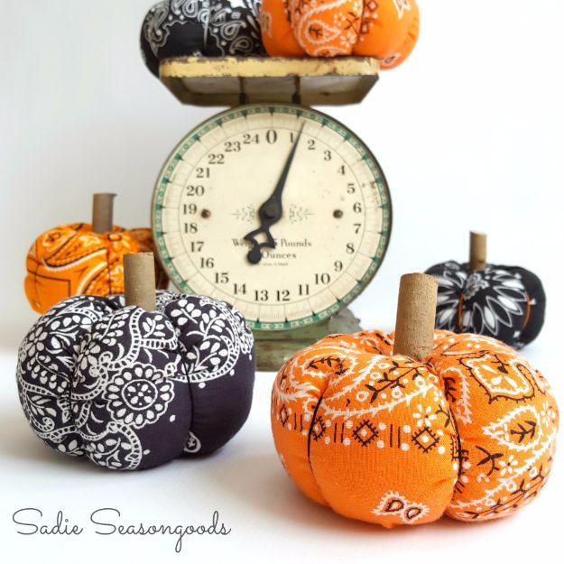 Bandana fabric pumpkins for fall, orange and black prints with cut twig stems around a vintage kitchen scale
