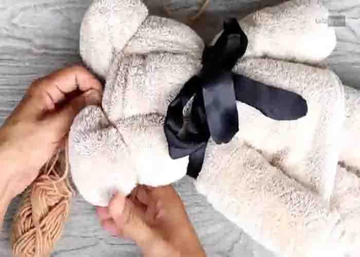 Making the ears of the bath towel teddy bear