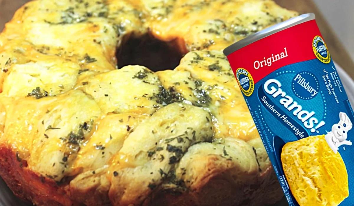 Savory garlic cheesy monkey bread made from canned biscuits layered with cheddar in a bundt pan recipe worth making twice