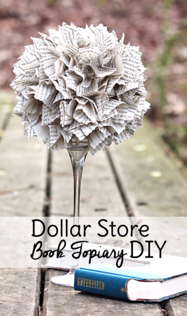 Dollar store book topiary graphic, ruffled book pages on a foam ball mounted on a tall silver candleholder