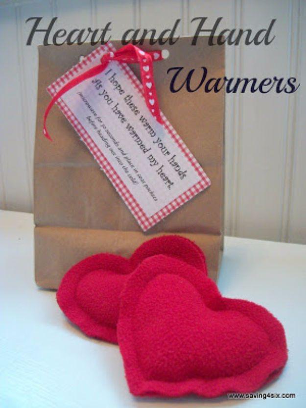 A pair of small fabric heart hand warmers filled with dry rice, a cozy handmade Valentine gift for her