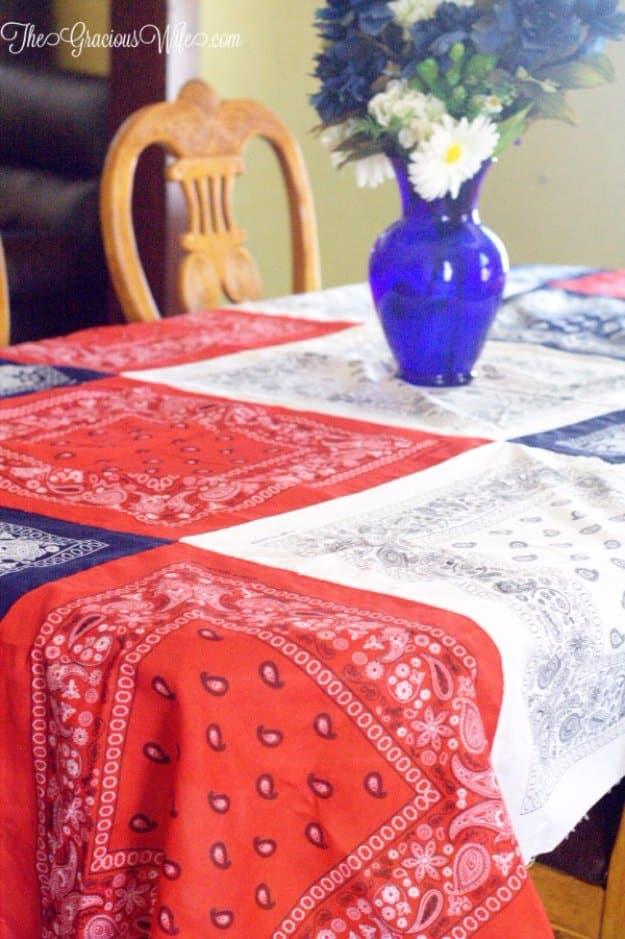 Easy DIY bandana tablecloth, a red white and blue bandana patchwork cloth on a dining table with a blue vase