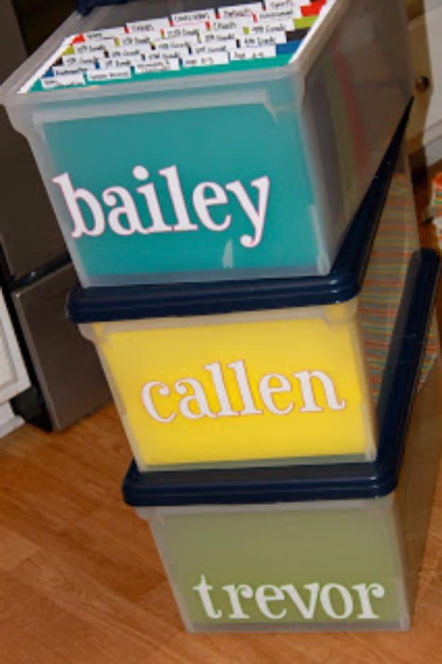 Baby boxes with names, three stacked clear bins lettered bailey callen and trevor over teal yellow and green paper backing