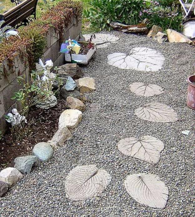 DIY garden stepping stones, pale concrete stones pressed with large leaf impressions set into a gravel garden path