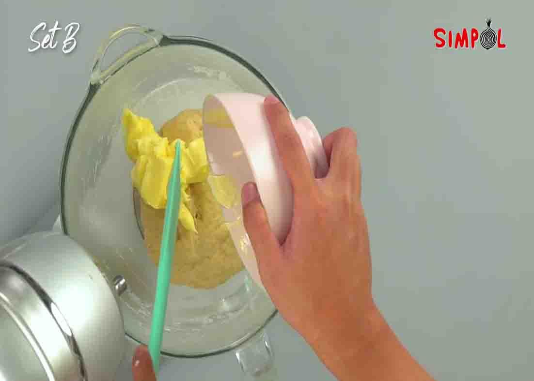 Adding butter to the bread dough