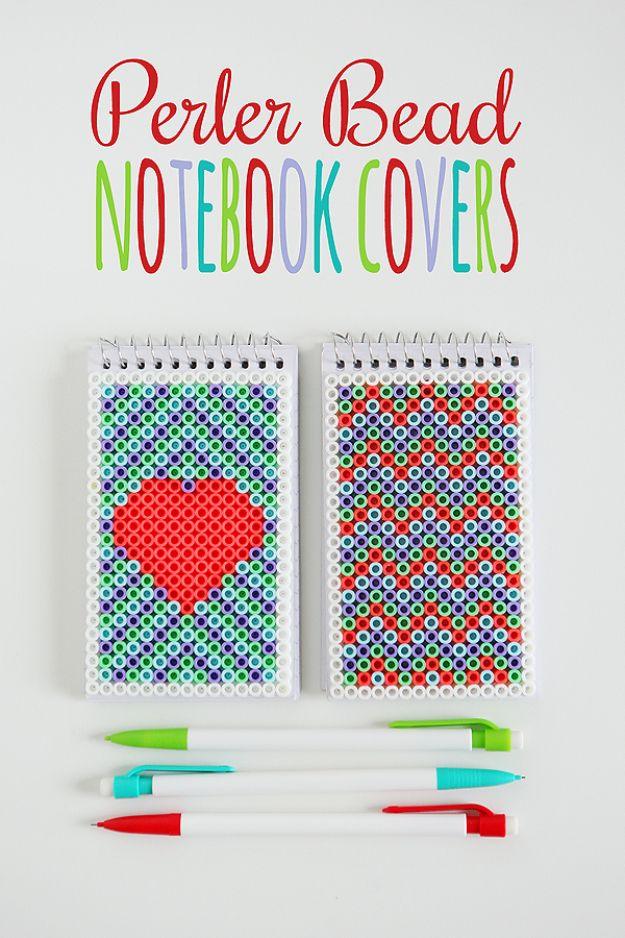 Perler bead notebook covers, two small notebooks with beaded heart and chevron panels beside four colored pens
