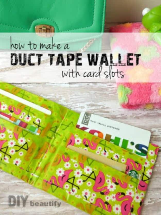 Make a duct tape wallet, an open green flamingo print duct tape wallet holding a store card and cash