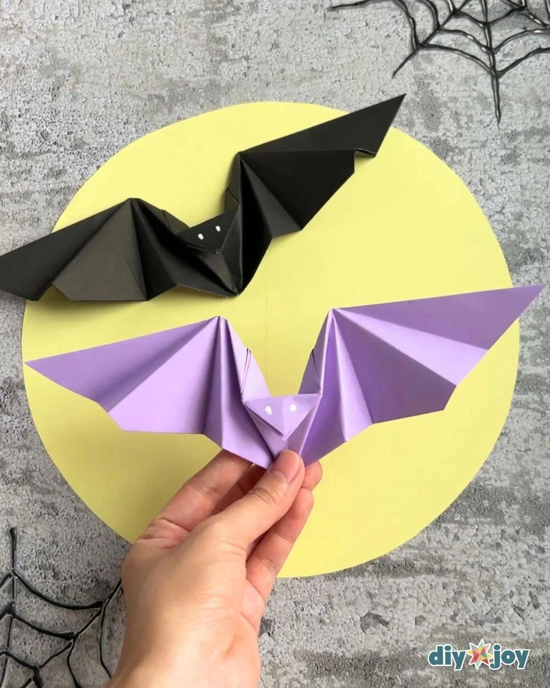 Easy Halloween paper bats made from folded origami paper with wings spread, the best part is that the wings actually flap.