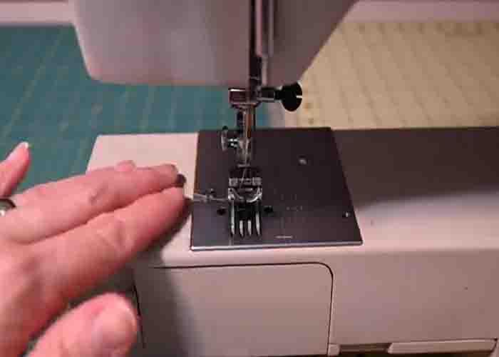 Holding your thread tails while sewing to avoid your bobbin thread getting tangled