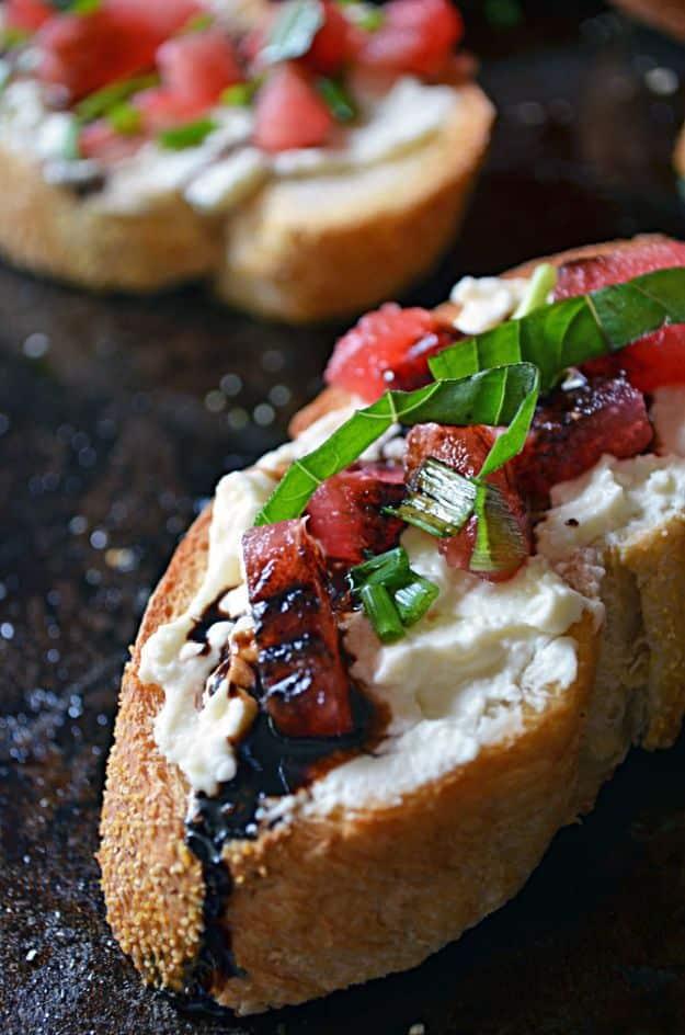 Watermelon bruschetta on toasted baguette slices with whipped feta, chopped watermelon, basil and balsamic