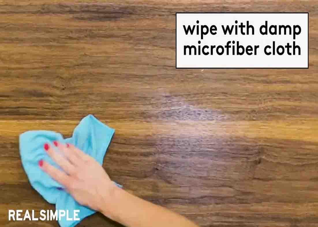 Wiping the wood furniture with a damp cloth