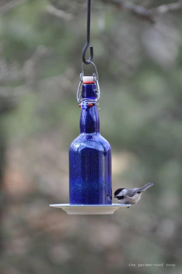 DIY Wine Bottle Bird Feeder, a simple backyard upgrade using basic supplies and a creative touch for a porch or garden path