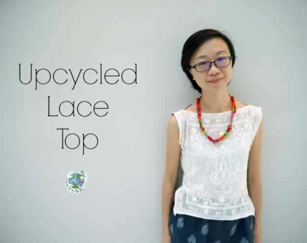 Refashioned lace top, a woman in a sleeveless white lace top and dark patterned trousers at a white wall