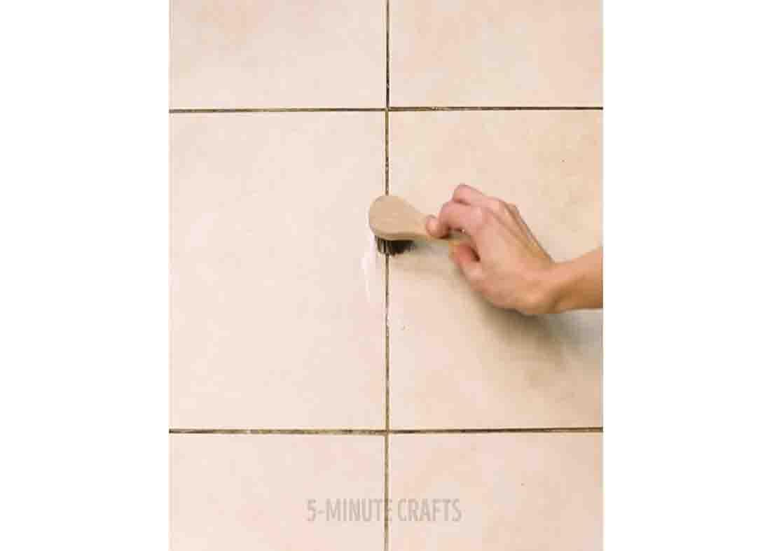 Brushing the grout with the homemade solution