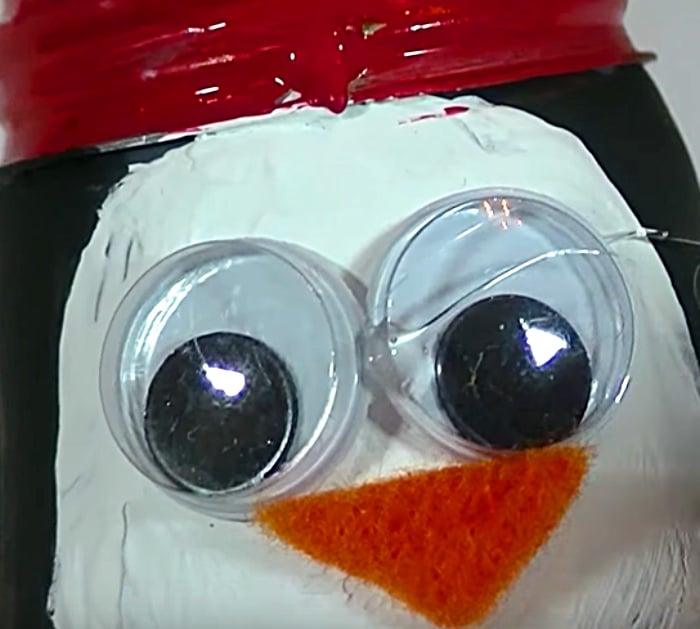 Learn this DIY Penguin Ornament Idea using Light Bulbs and paint