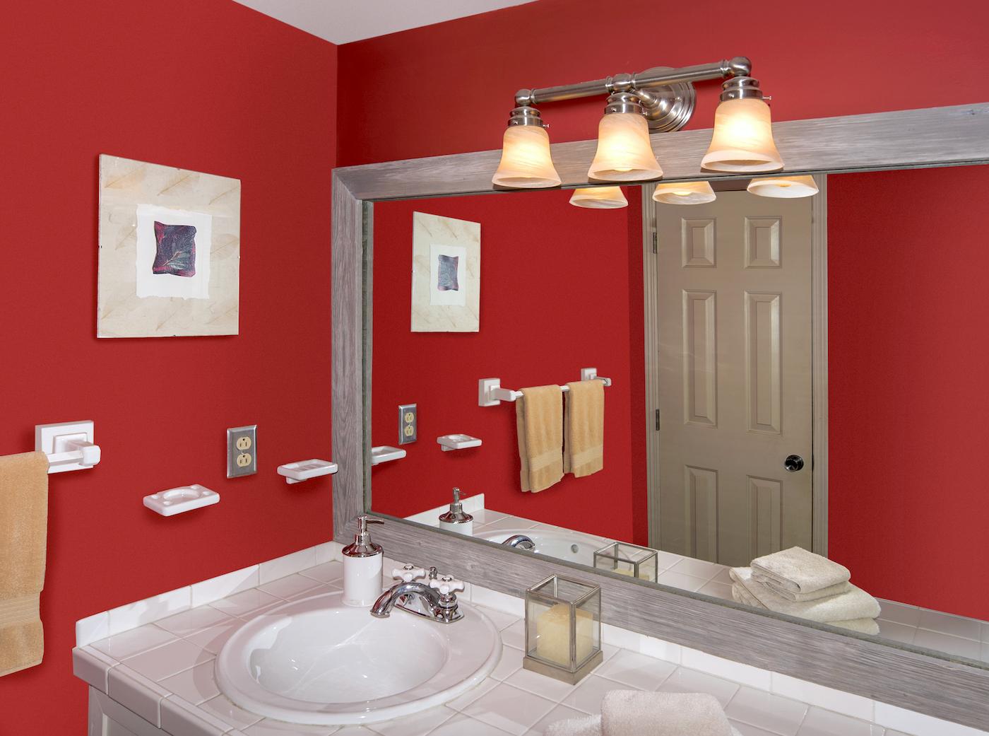 Wood framed bathroom mirror, a large mirror with a weathered grey wood frame over a white tiled bathroom vanity