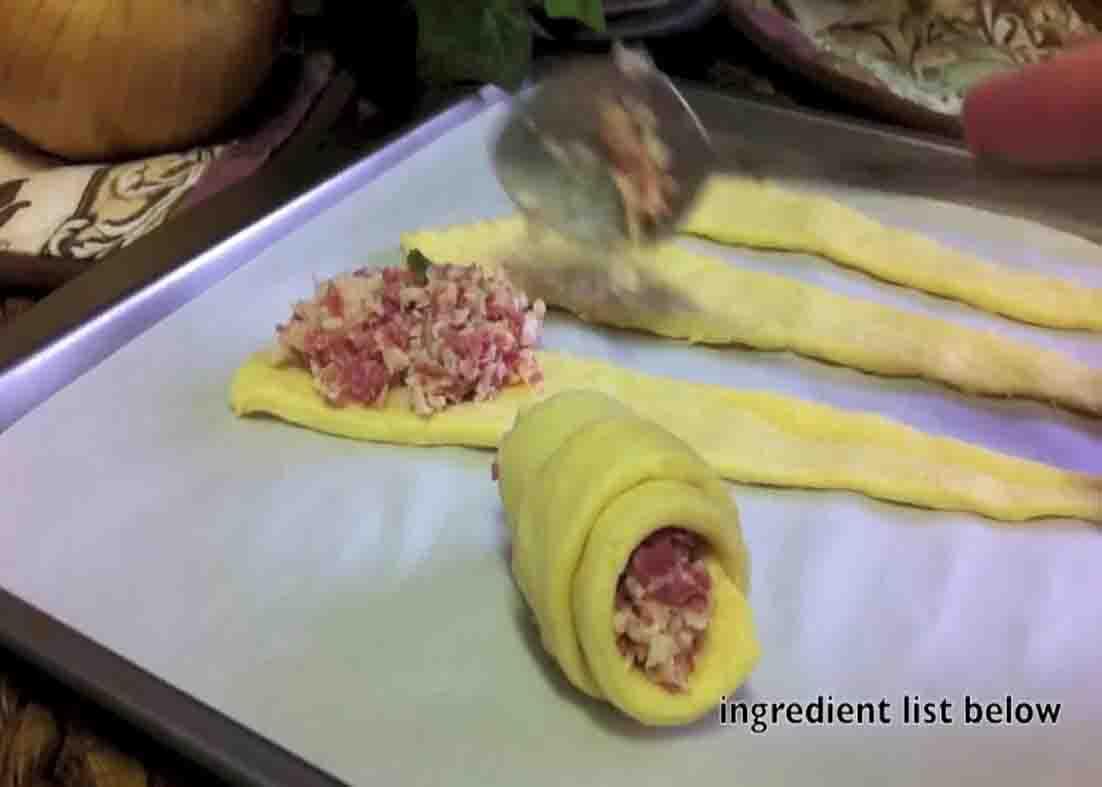 Adding the reuben bites filling to the crescent rolls