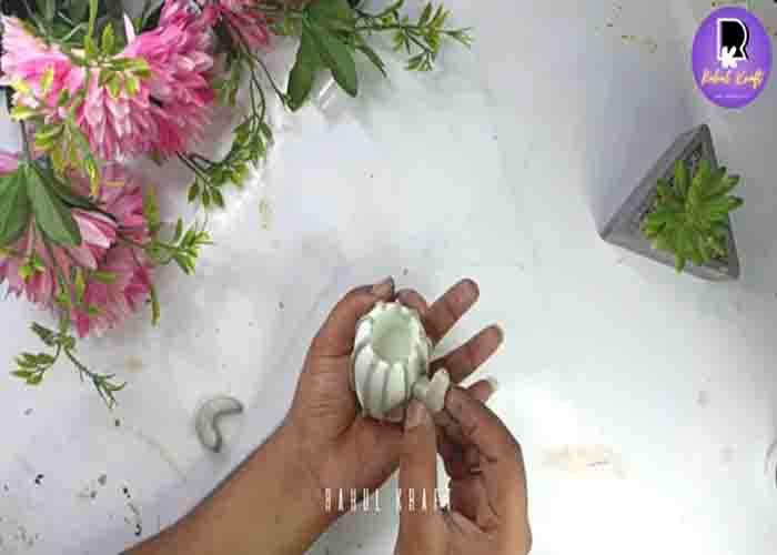 Adding the clay cactus branches into the plant holder