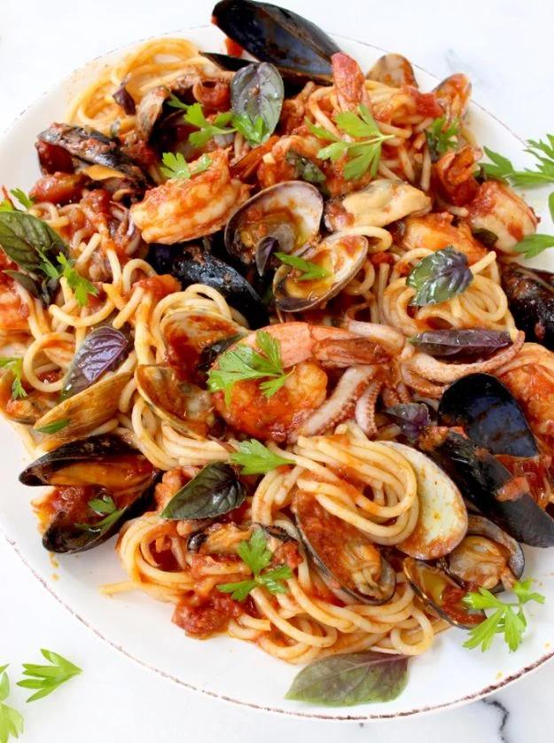 Frutti di mare spaghetti with clams, mussels, shrimp and squid in a red arrabbiata sauce with fresh basil