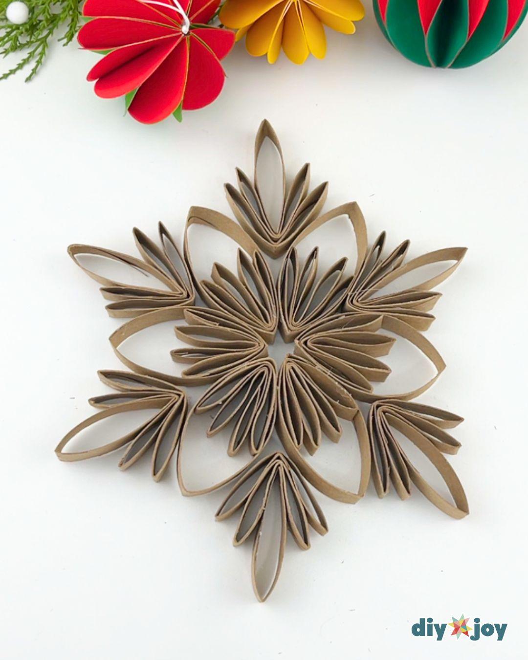 Homemade Christmas Ornaments Snowflake Toilet Paper Tubes — gluing the outer layer