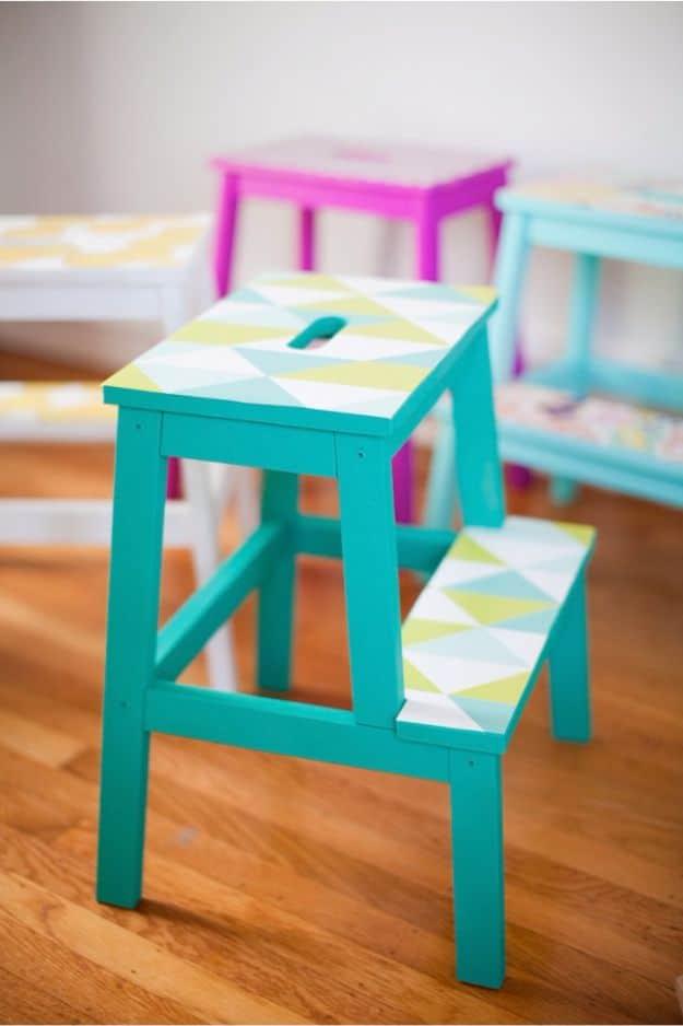 DIY wallpaper stools, IKEA step stools painted teal pink and white with geometric triangle wallpaper on the treads