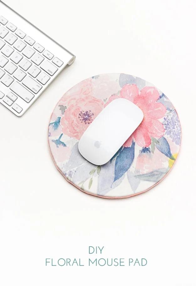 DIY floral mouse pad, a round cork mouse pad covered in pink and blue floral fabric beside a white keyboard and mouse