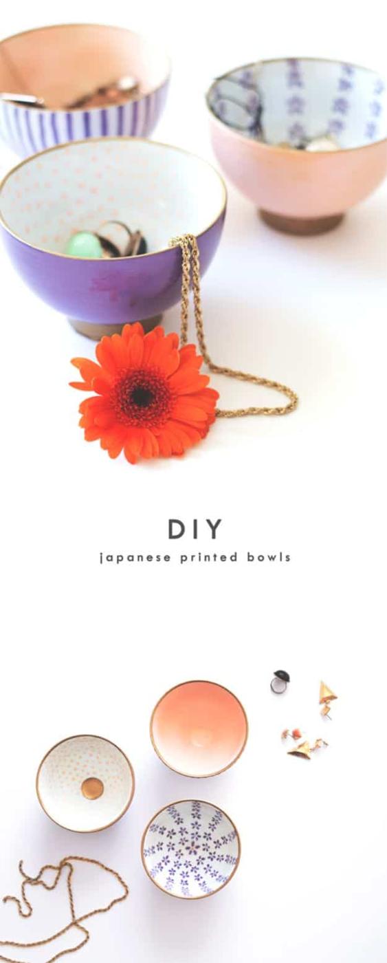 Hand painted porcelain bowls in lilac, peach and blue patterns above a flat lay of more bowls and gold wire