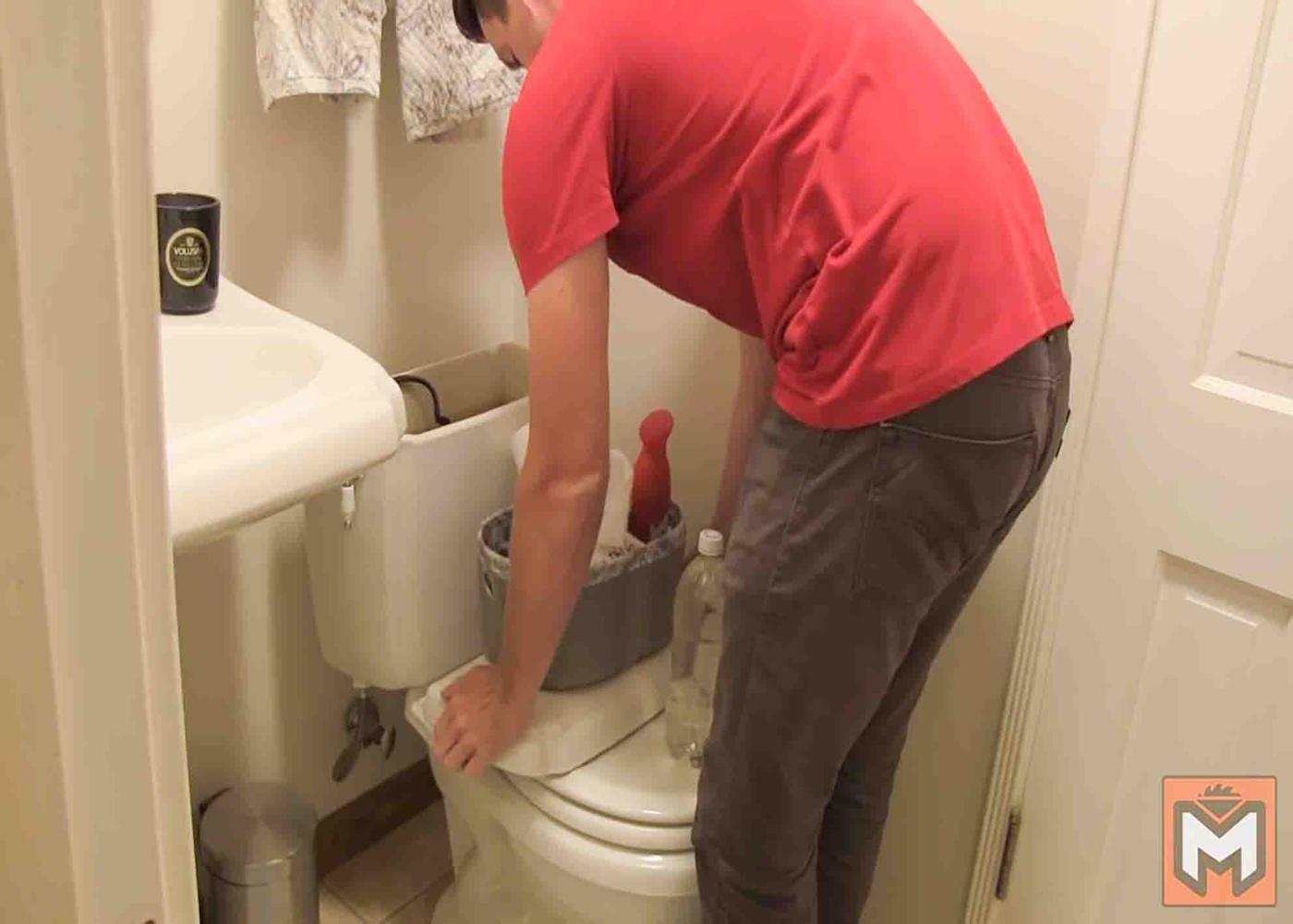 Placing a 1-liter bottle filled with water to take up some space in the flush tank.