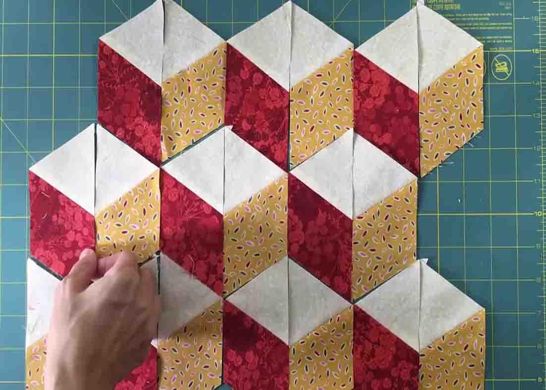 Laying out the blocks to make the tumbling blocks quilt top