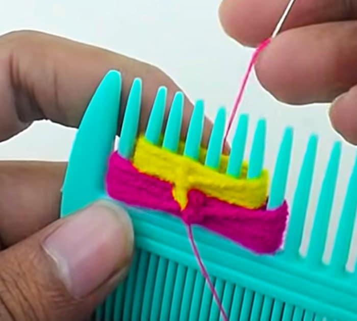 Make a yarn flower using a comb