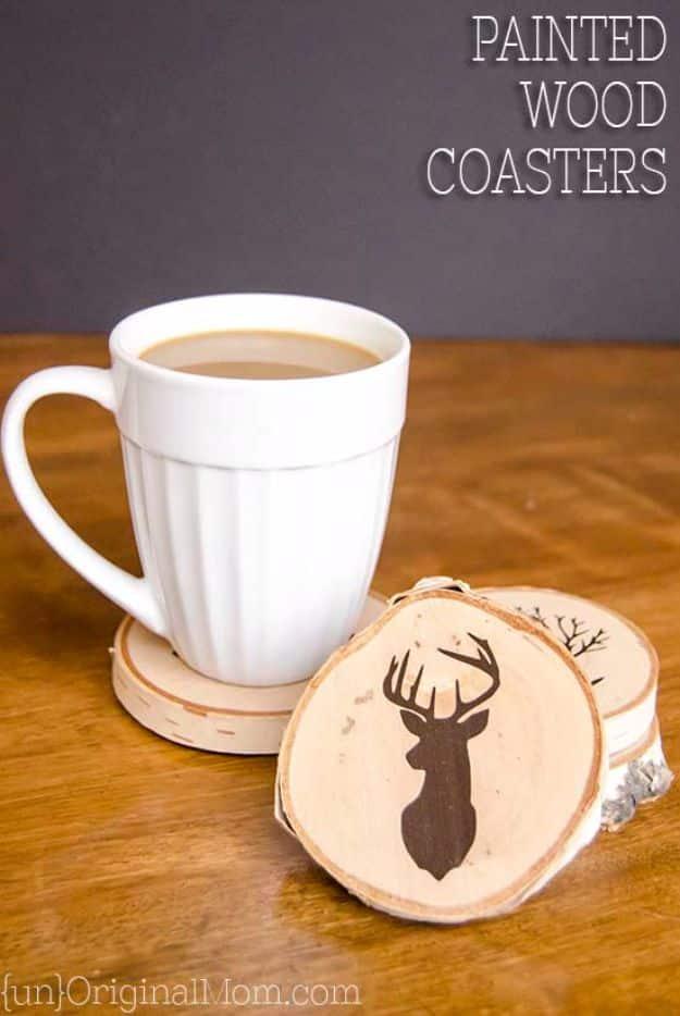 A set of painted birch wood slice coasters with a stencil design, a rustic handmade gift idea for him