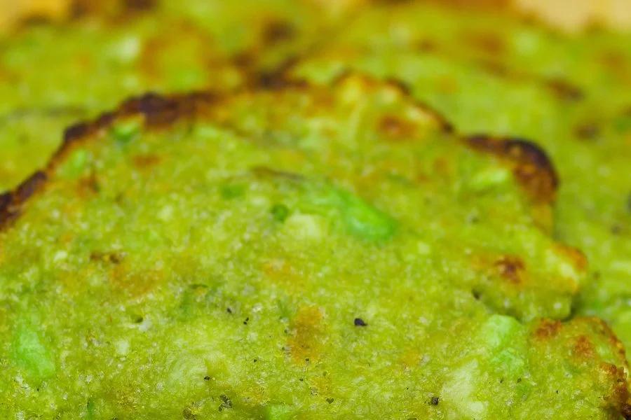 Close up of crispy avocado chips showing golden, cheesy edges