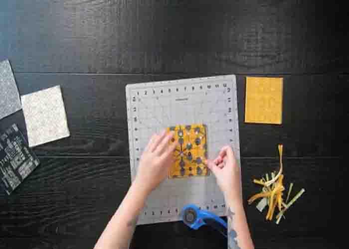 Cutting the charm pack into smaller squares for the table runner quilt