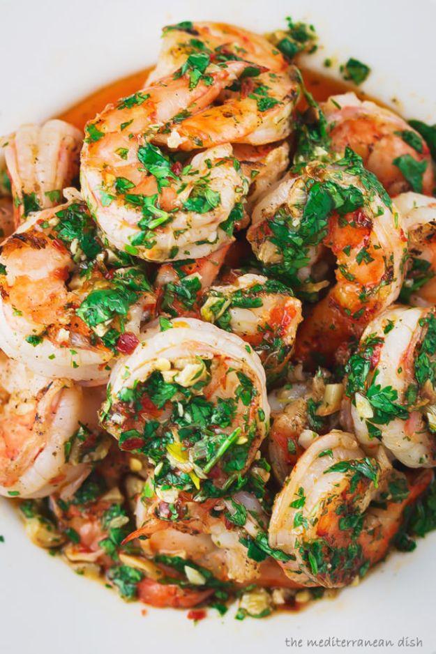 Grilled shrimp with garlic cilantro sauce piled into a white bowl, covered in plenty of chopped fresh cilantro