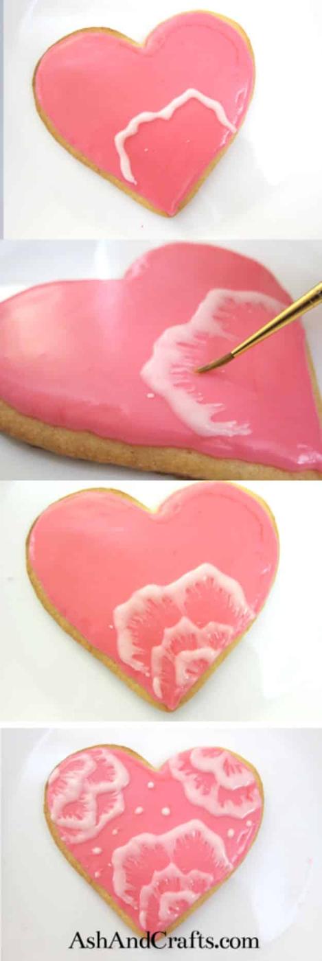 Brush embroidery cookies with piped icing petals pulled inward with a damp brush into feathered edges