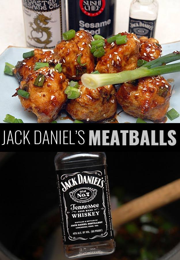 Jack Daniels meatballs glazed in whiskey sauce with sesame seeds and sliced scallions on a white plate