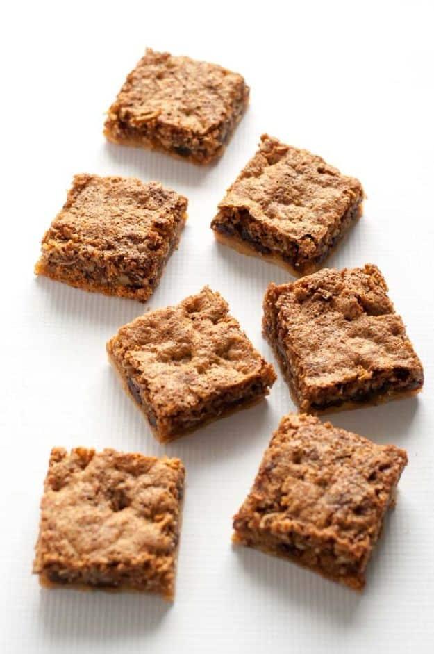 Canadian butter tart squares with a nut crust, gooey brown sugar filling, raisins and chopped pecans