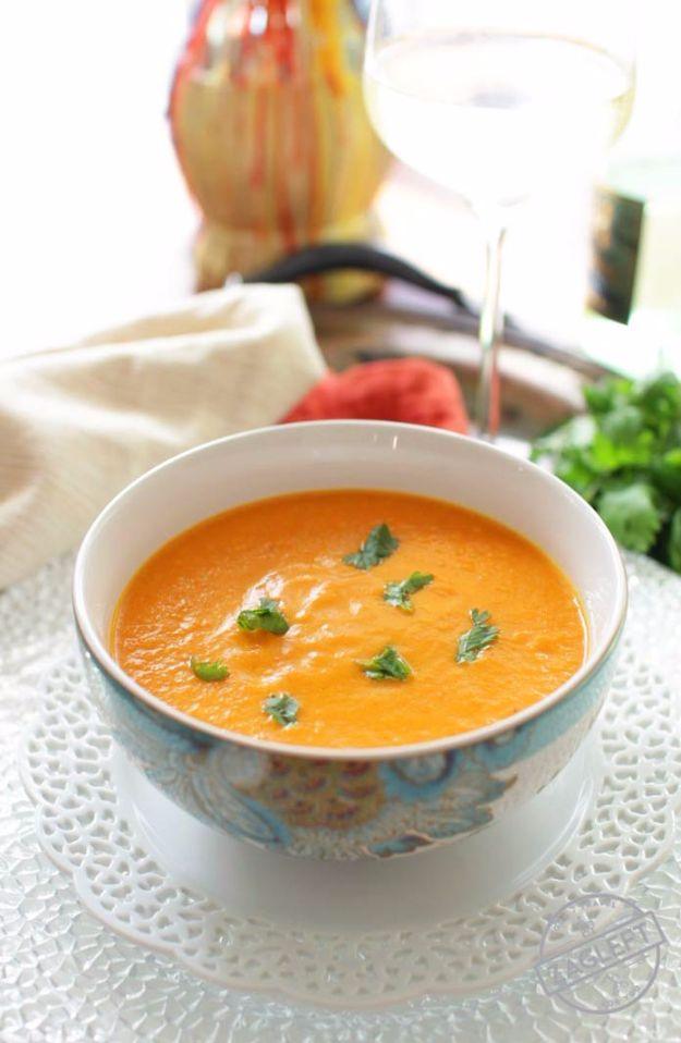 Curried carrot soup for one in a bowl, bright orange and creamy with coconut milk and chopped cilantro