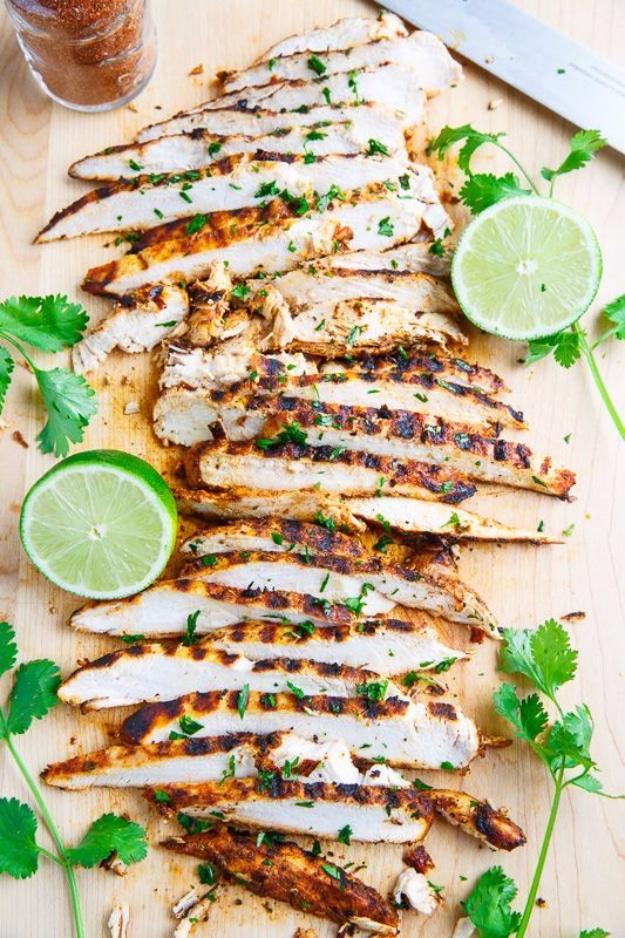 Sliced taco lime grilled chicken with lime halves and fresh cilantro, an easy 3 ingredient grilling recipe