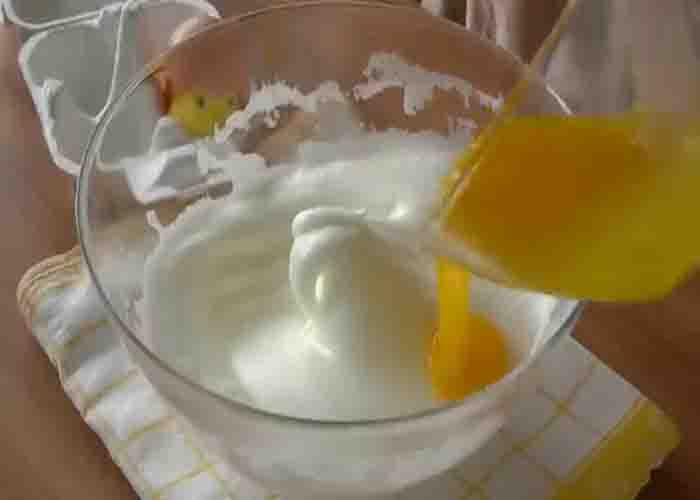Mixing the yolks and whites for the souffle omelet recipe